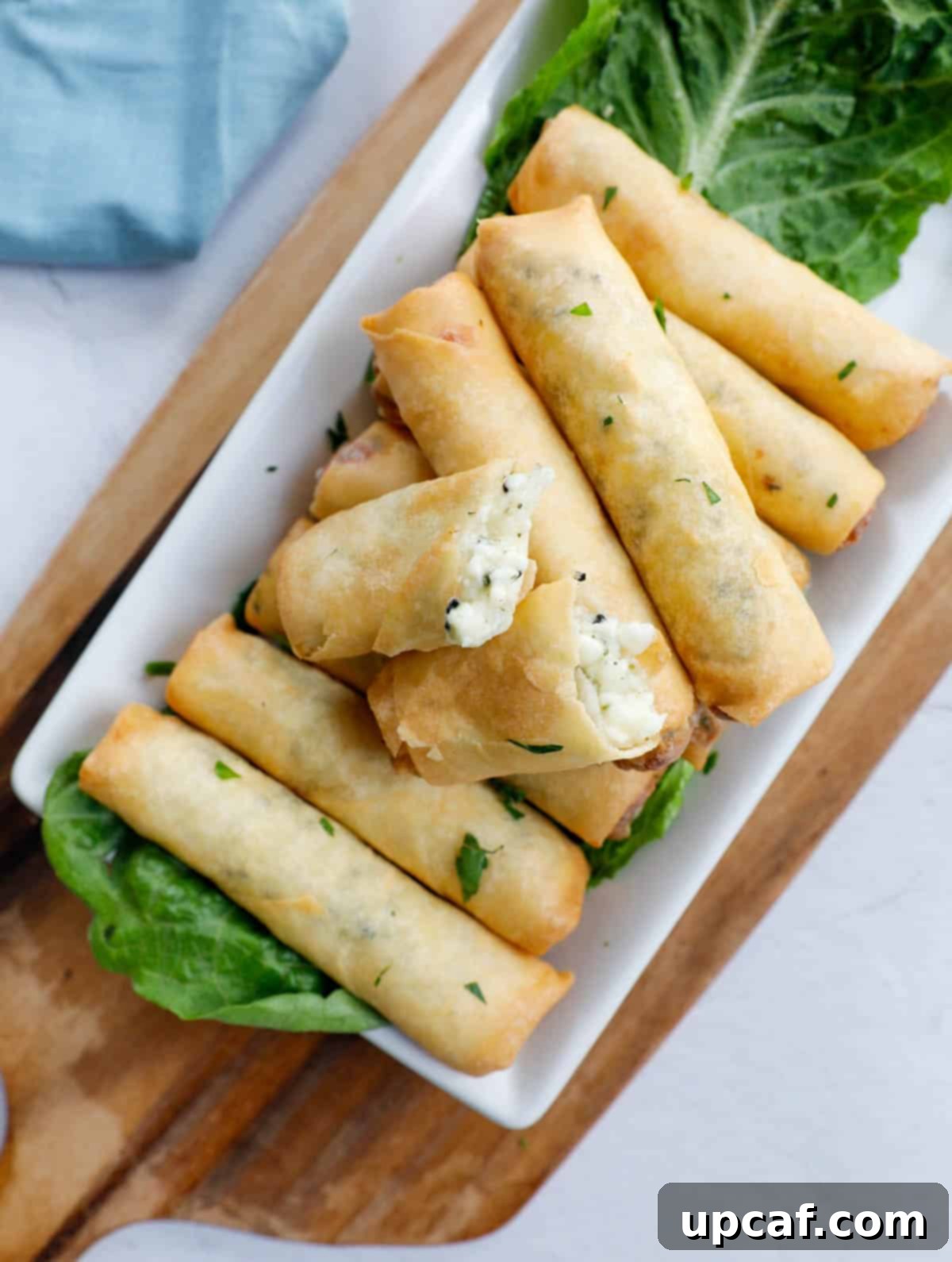 Fried Lebanese Cheese Rolls arranged beautifully on a rustic wooden board.