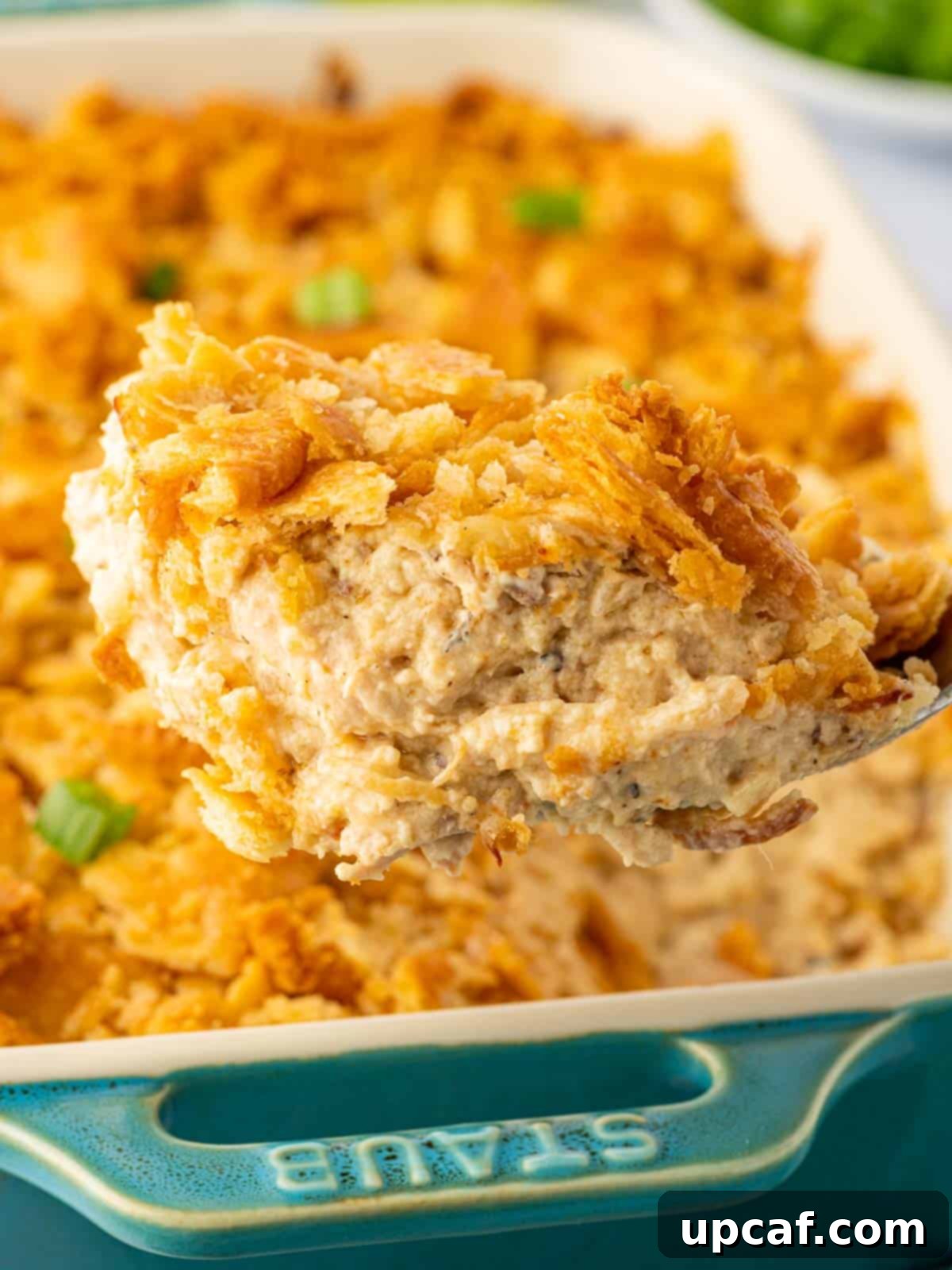 A scoop of million dollar chicken is served.