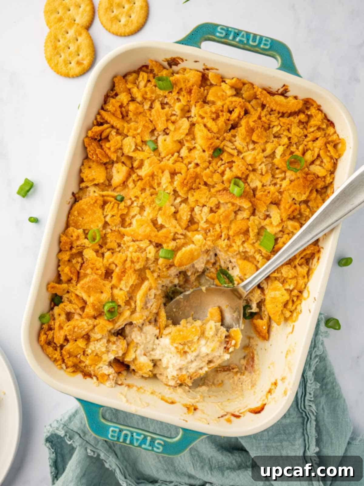 A spoon rests in a chicken casserole dish.