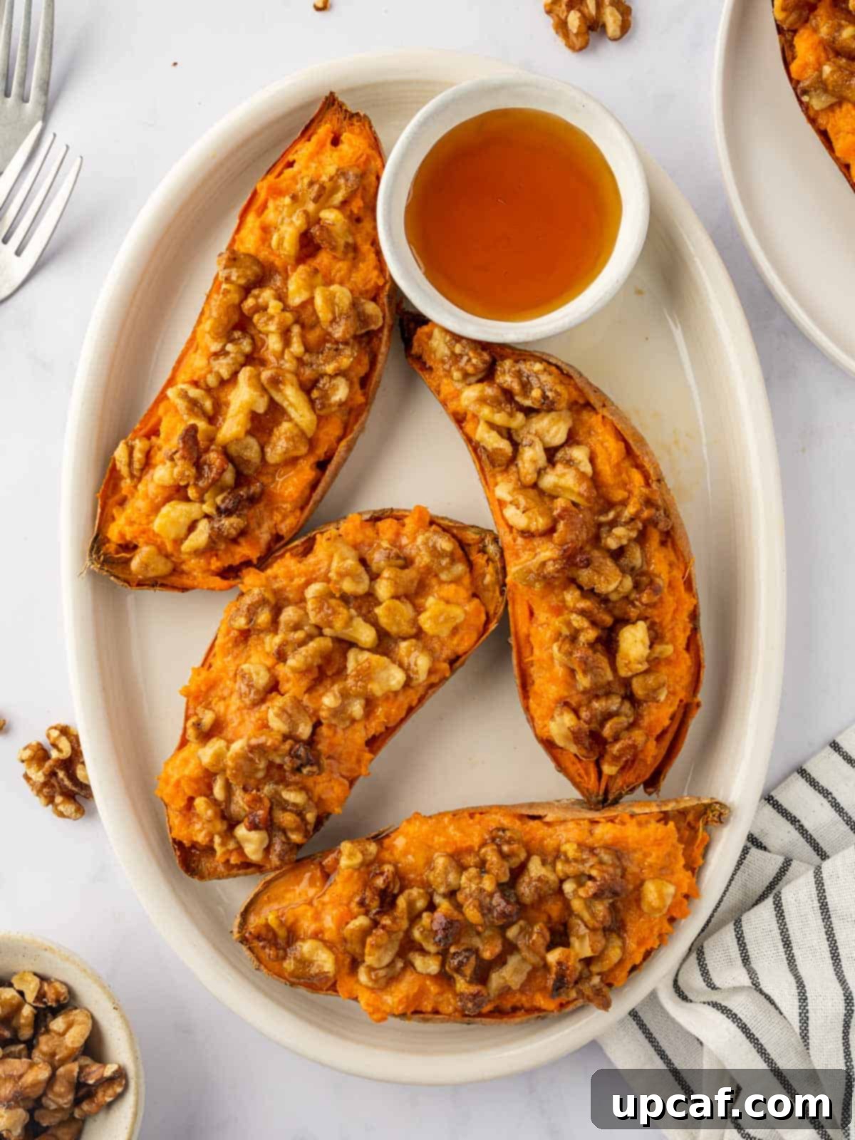 Maple Glazed Sweet Potatoes with Toasted Walnuts 2 Twice baked sweet potatoes on a tray, garnished and ready to serve.
