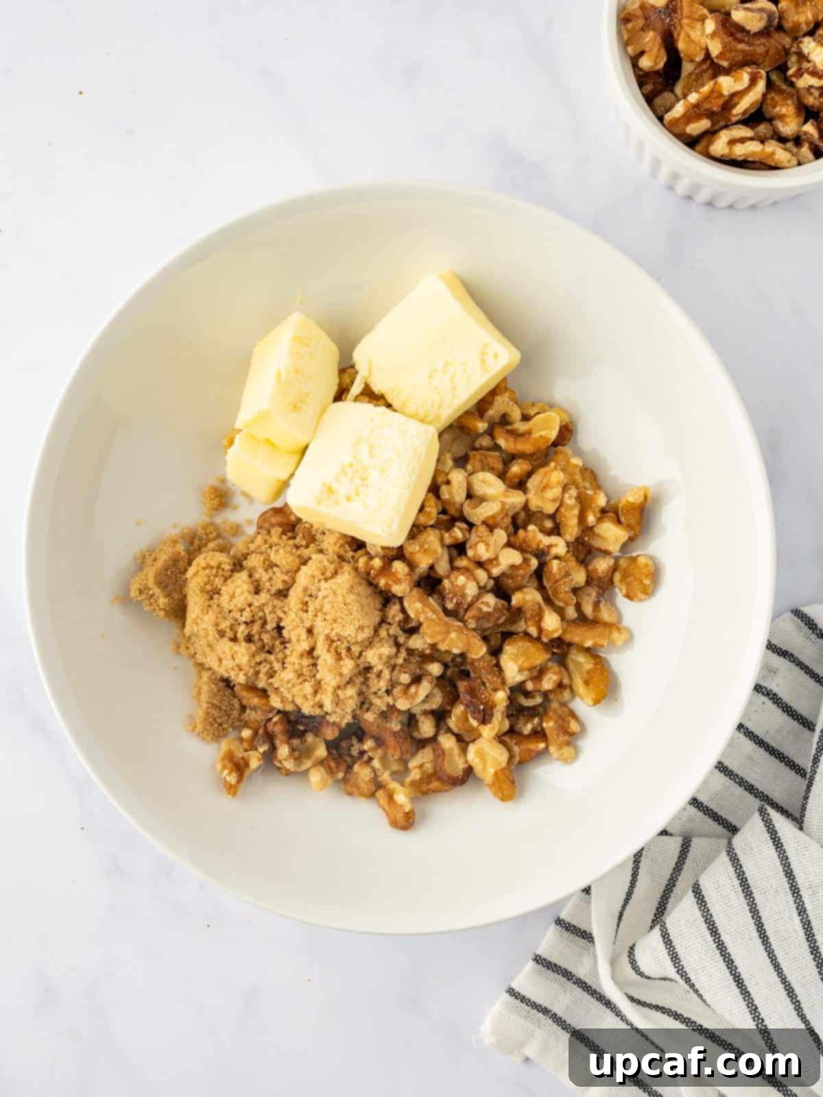 Maple Glazed Sweet Potatoes with Toasted Walnuts 5 Mixing the maple walnut topping ingredients in a bowl.