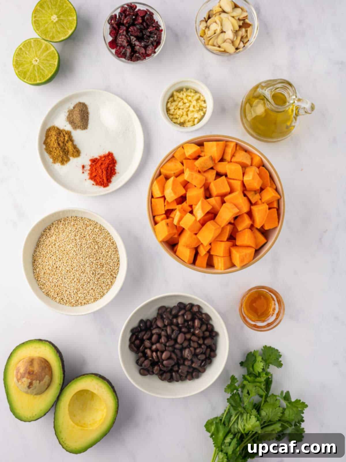 Roasted Sweet Potato Quinoa Salad 3 Ingredients needed for roasted sweet potato quinoa salad including sweet potatoes, olive oil, spices, black beans, avocado, cranberries, almonds, and cilantro.
