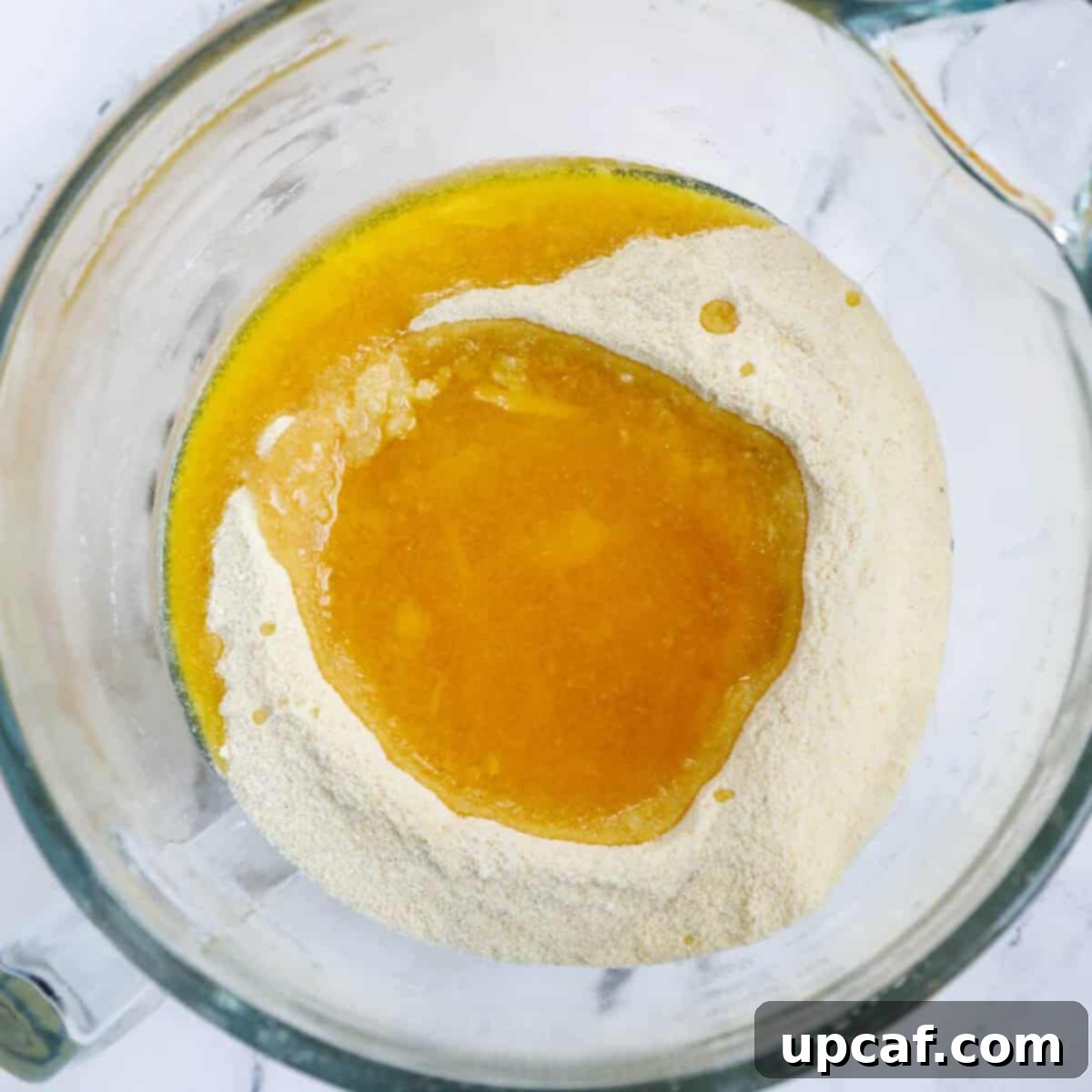 Warm ghee poured over dry mixture.