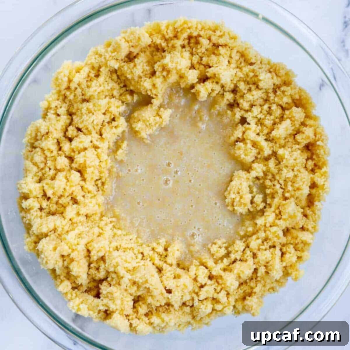 Maamoul dough in a bowl after milk was added to it.