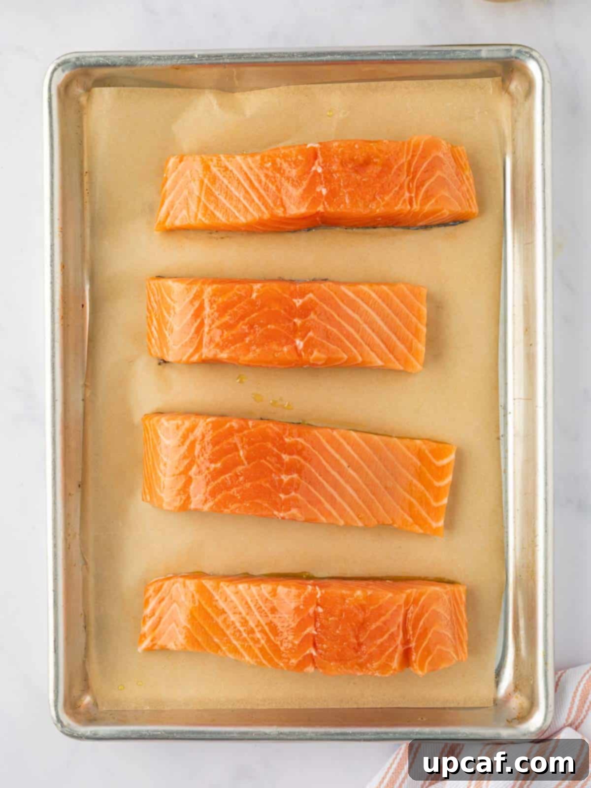 Caramelized Brown Sugar Salmon 4 Fresh salmon filets on a tray.