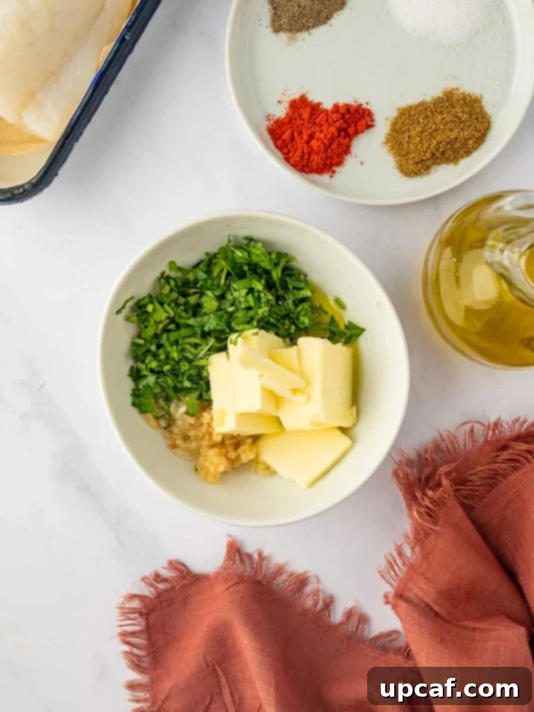 A close-up of fresh garlic, butter, and herbs being mixed for the cod marinade.