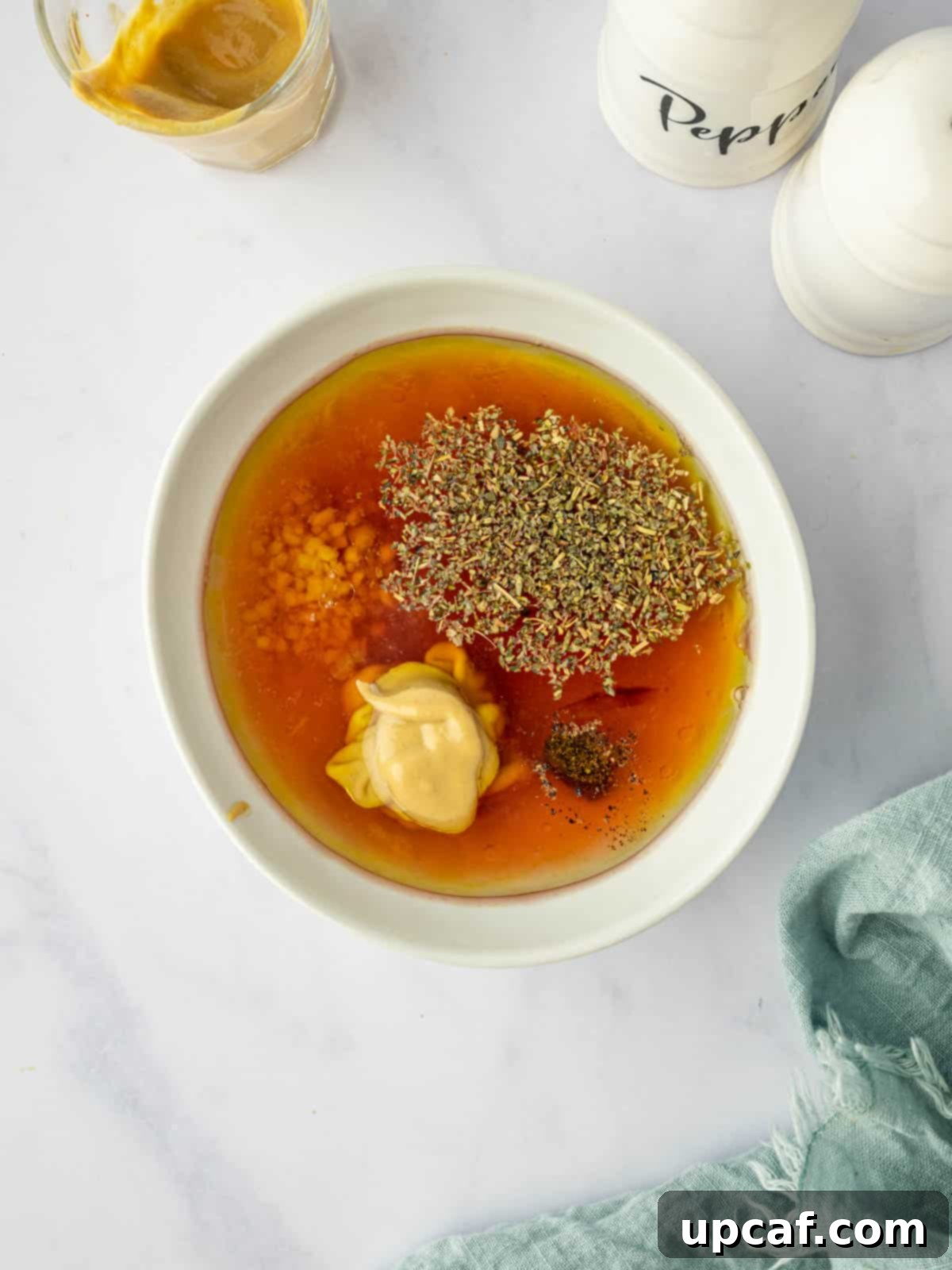 Close-up shot of a small bowl where the steakhouse salad dressing ingredients are being whisked together vigorously.