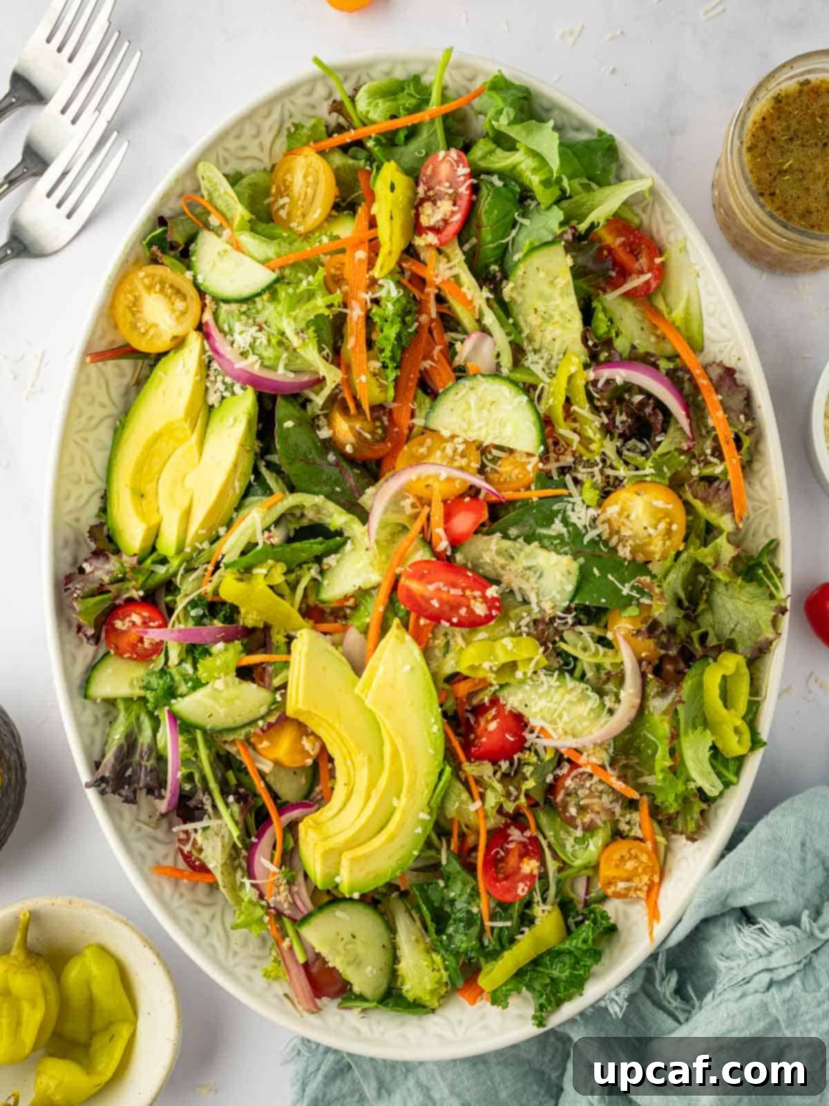 A beautifully presented platter of a classic house salad, inviting and ready to be served as a refreshing accompaniment.