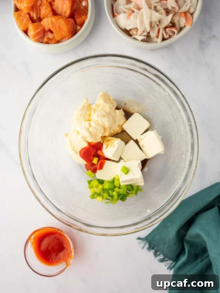 Mixing cream cheese and other creamy ingredients in a bowl for the salmon layer.