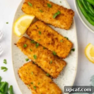 air fried mahi mahi fish fillet in a platter with lemon slices.