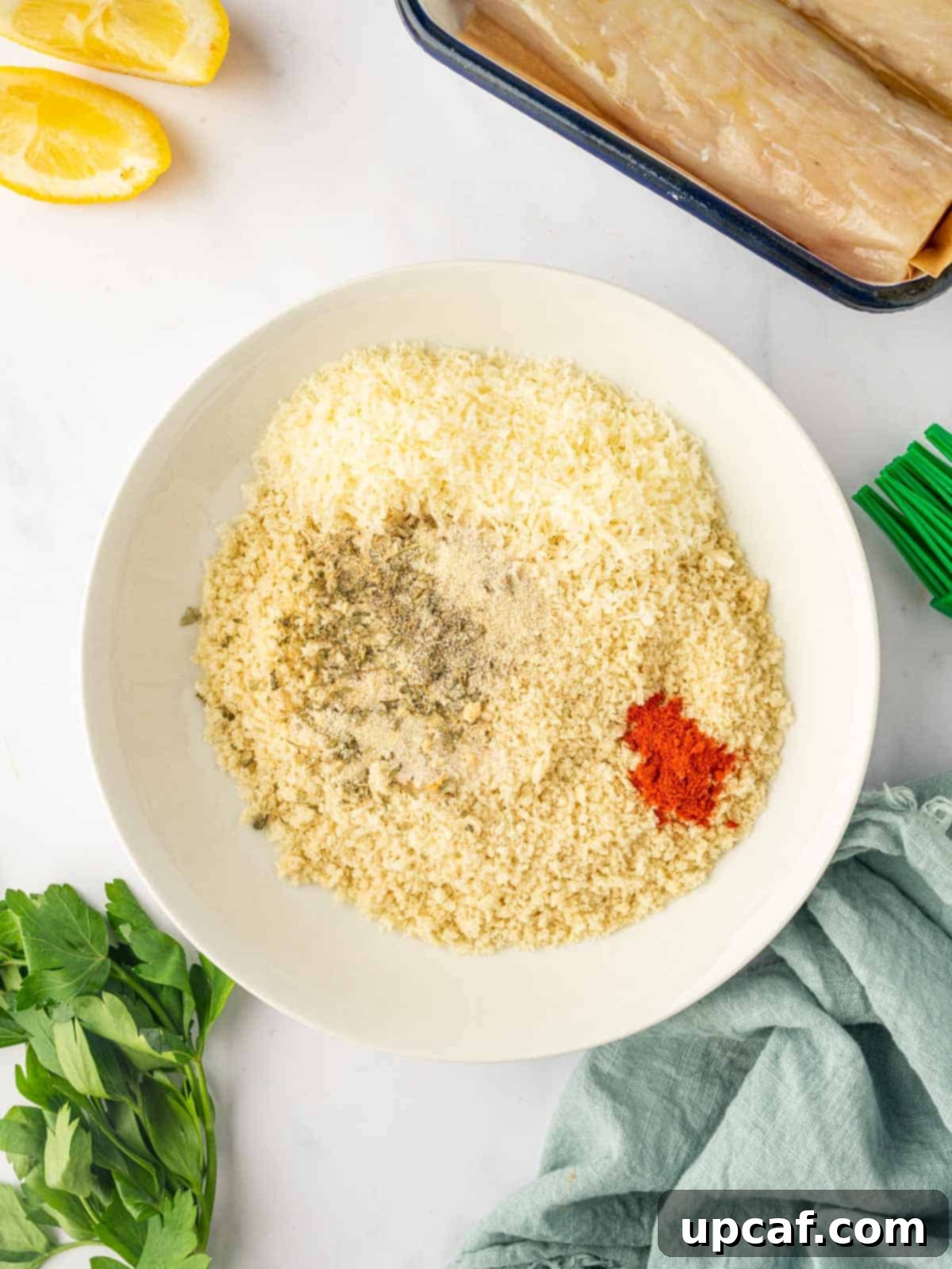 A close-up shot of panko crumbs mixed with a variety of spices, expertly blended in a bowl, forming a perfect coating mixture.