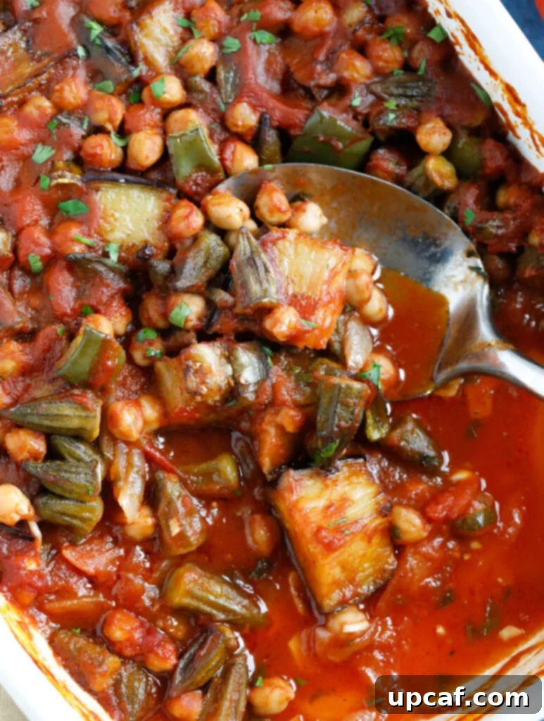  A spoon servings Lebanese Moussaka from the baking dish