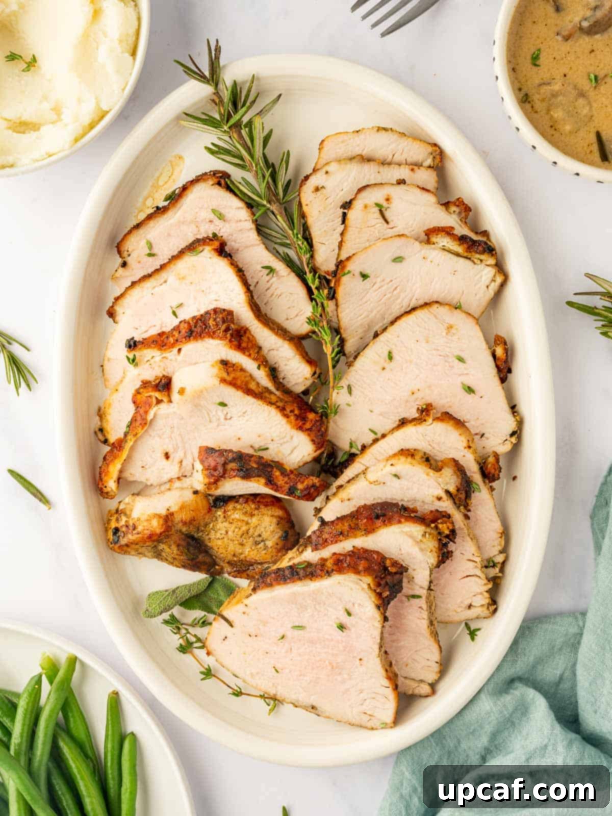 A platter of turkey breast slices, golden brown and juicy.