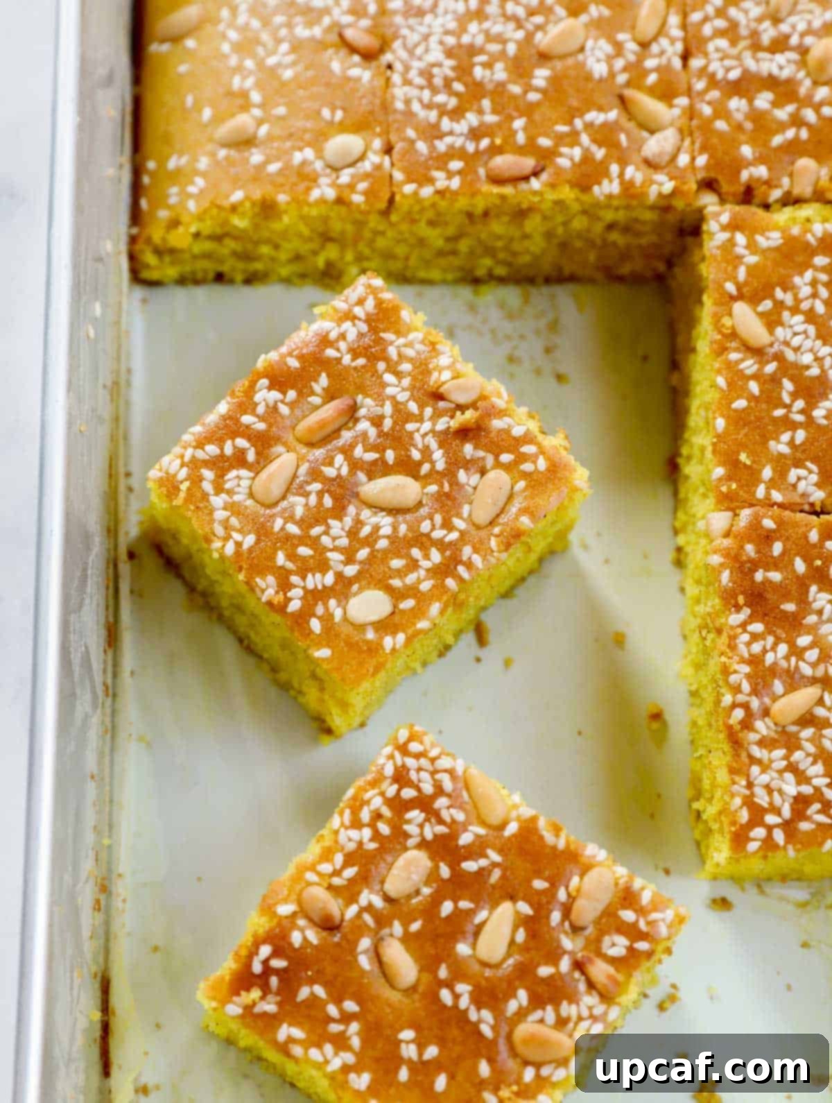Pieces of Lebanese Turmeric Cake (Sfouf) in a baking tray.