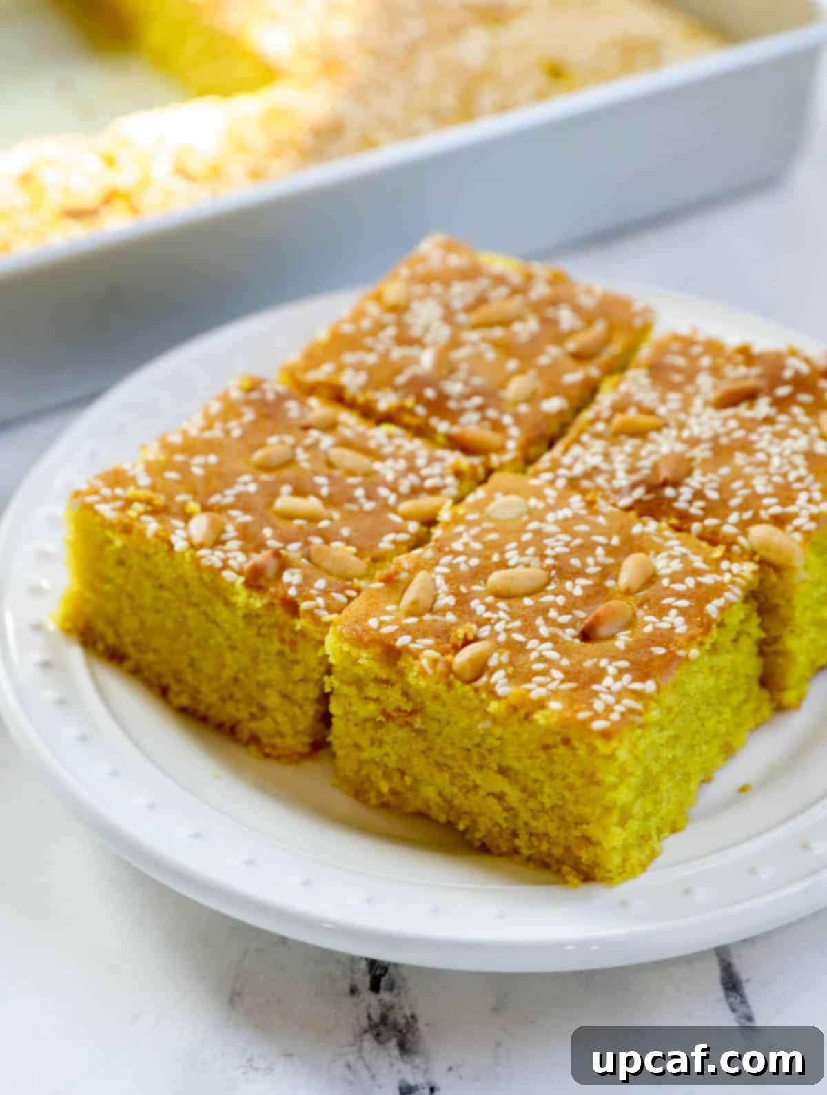 Pieces of Lebanese Turmeric Cake (sfouf) on a plate.