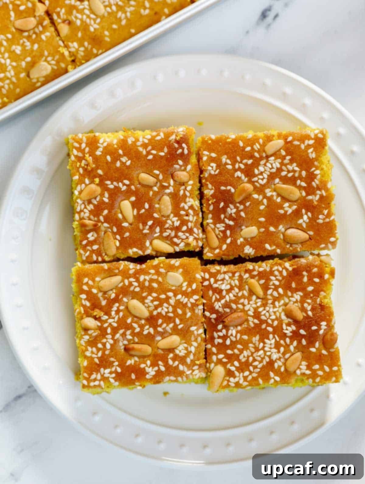 Pieces of Lebanese Turmeric Cake (sfouf) on a plate.