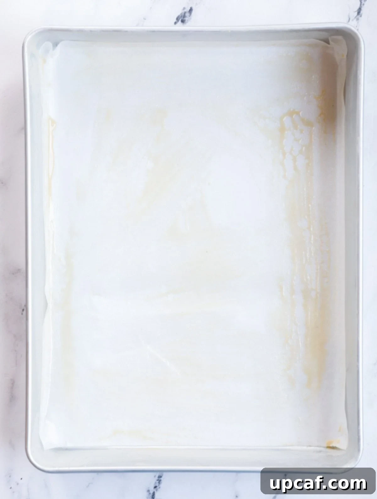 Cake pan brushed with tahini paste.