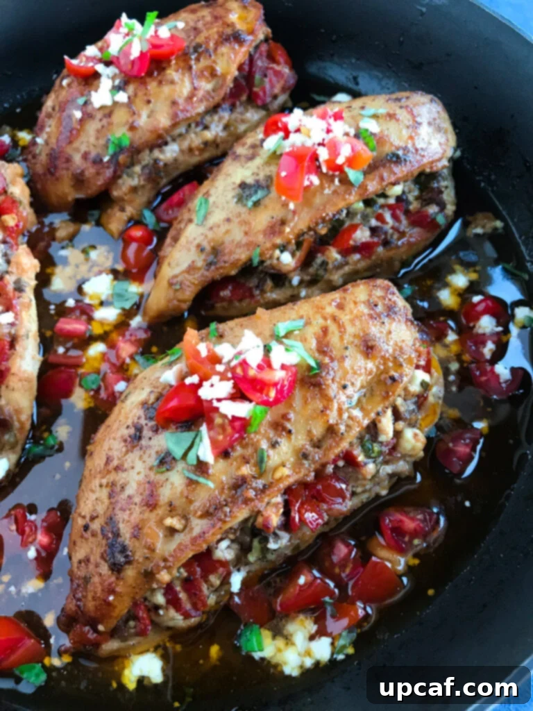 Close-up of a perfectly cooked Bruschetta Stuffed Chicken, showcasing the vibrant filling.