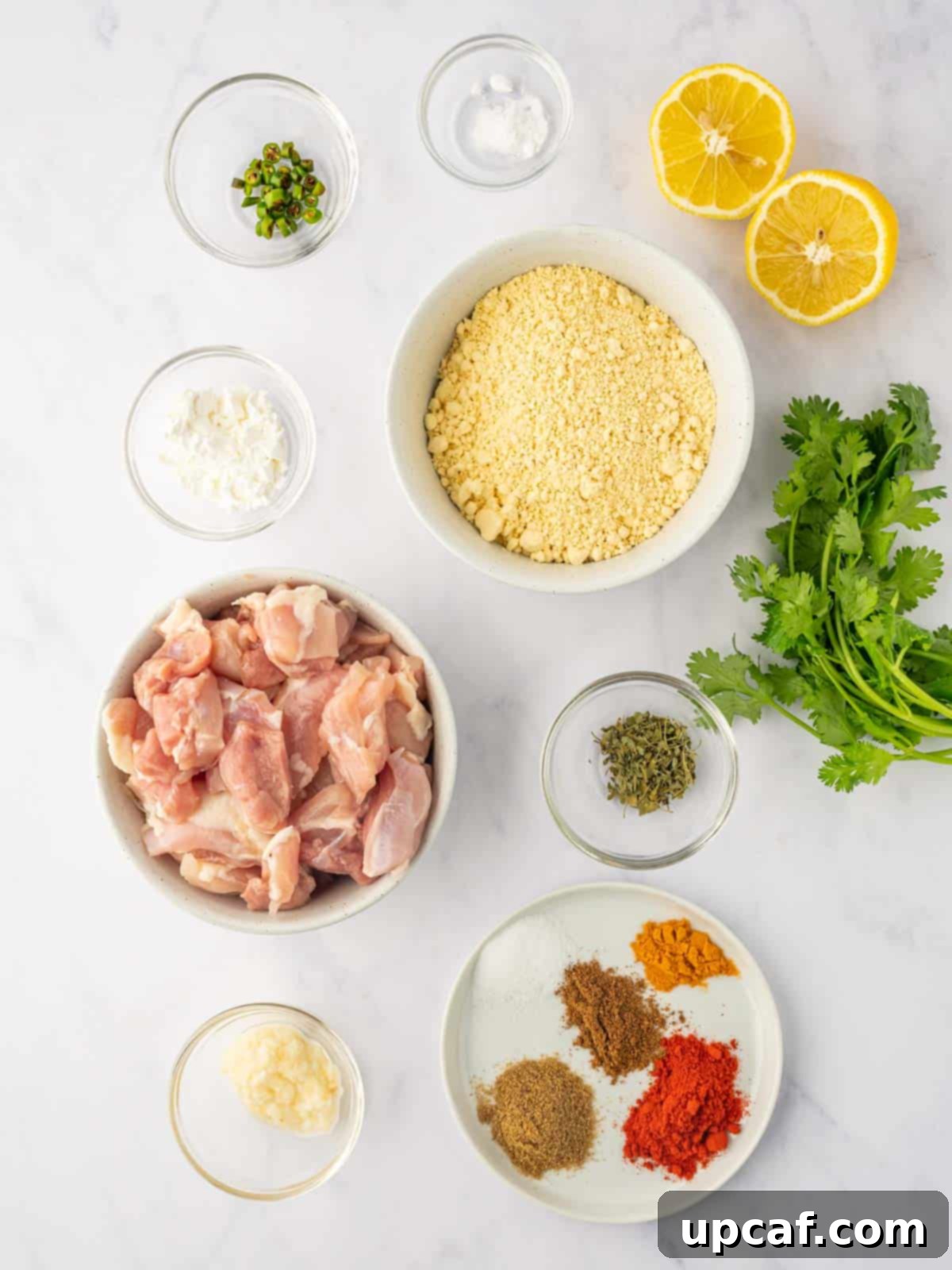 Golden Crispy Chicken Pakora 3 A flat lay photograph showcasing all the ingredients required for making chicken pakora, neatly arranged on a counter.