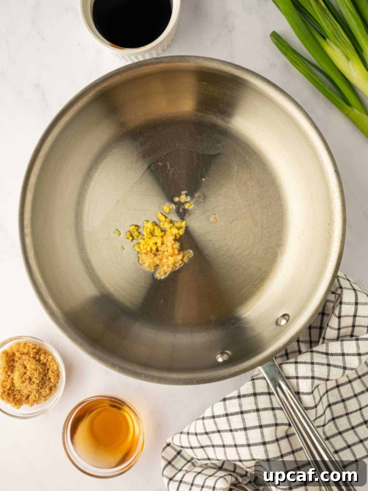 Sweet and Sticky Panda Express Teriyaki Chicken 5 Fresh garlic is sauteed in a skillet, filling the air with a savory aroma.