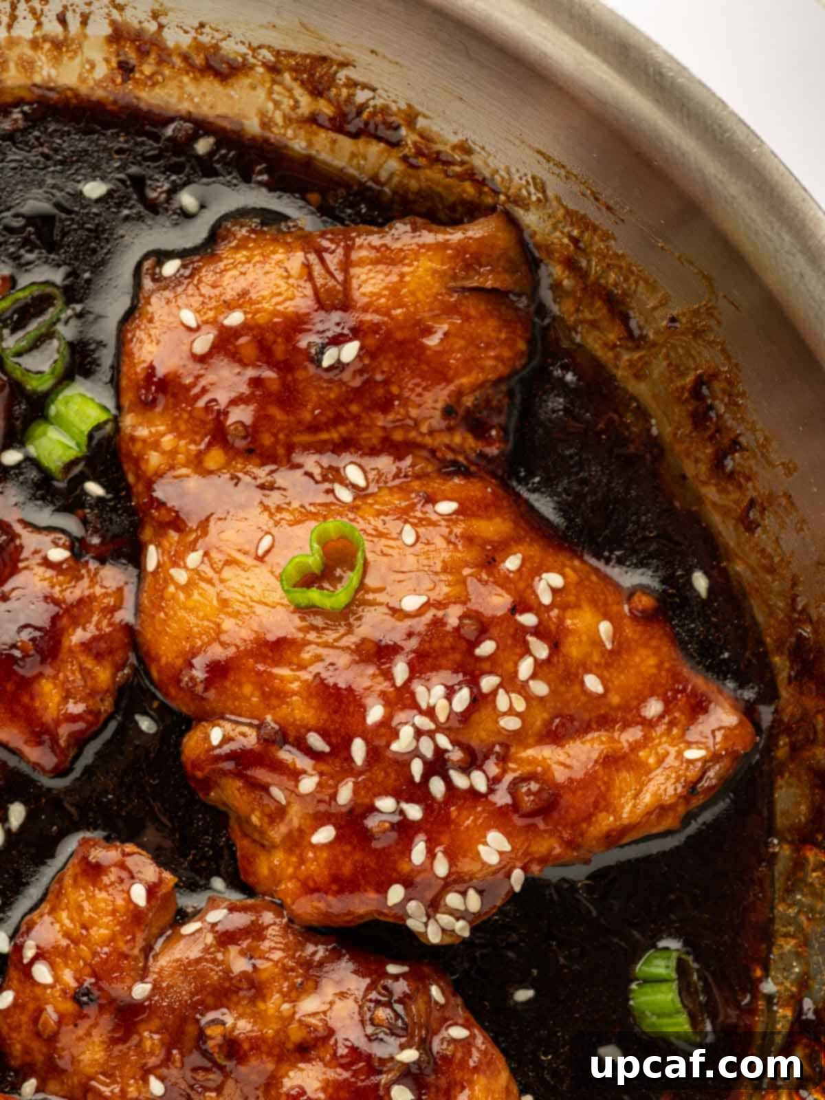 Sweet and Sticky Panda Express Teriyaki Chicken 9 Closeup shot of juicy chicken thighs generously coated in a rich, glossy teriyaki sauce.