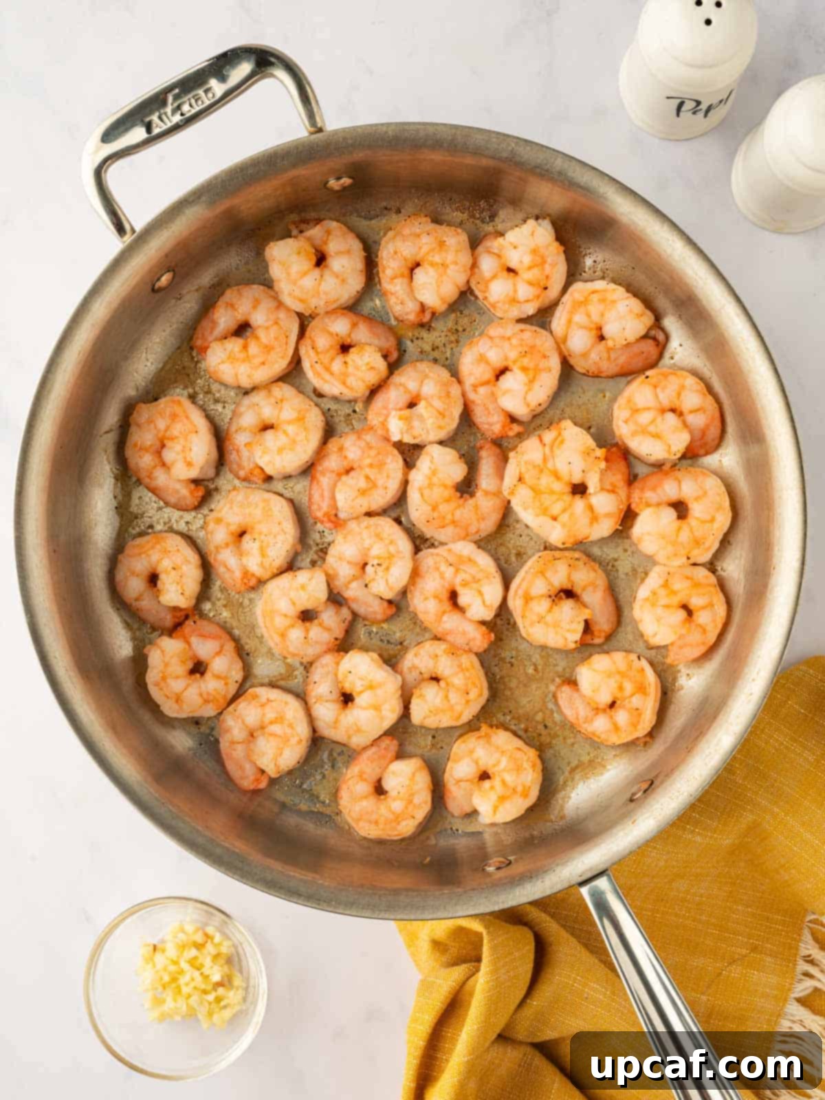 Cooked shrimp in a skillet.