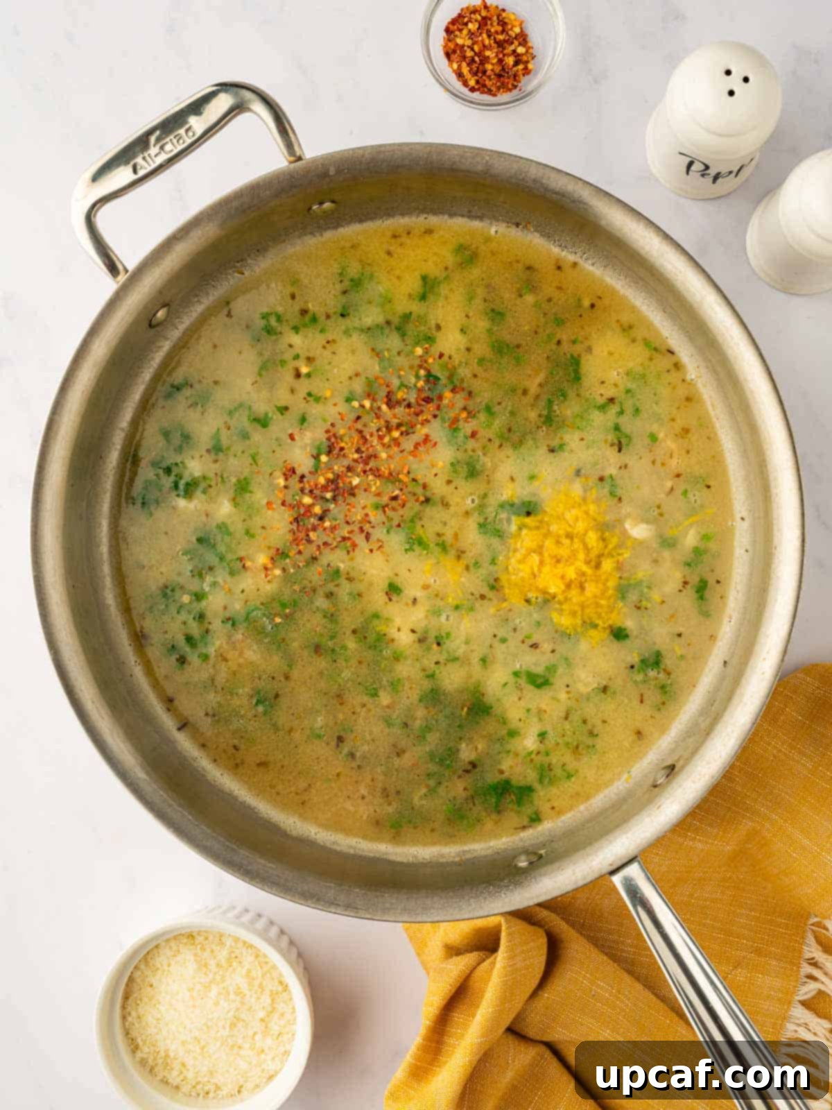 Adding herbs and seasonings to the skillet.