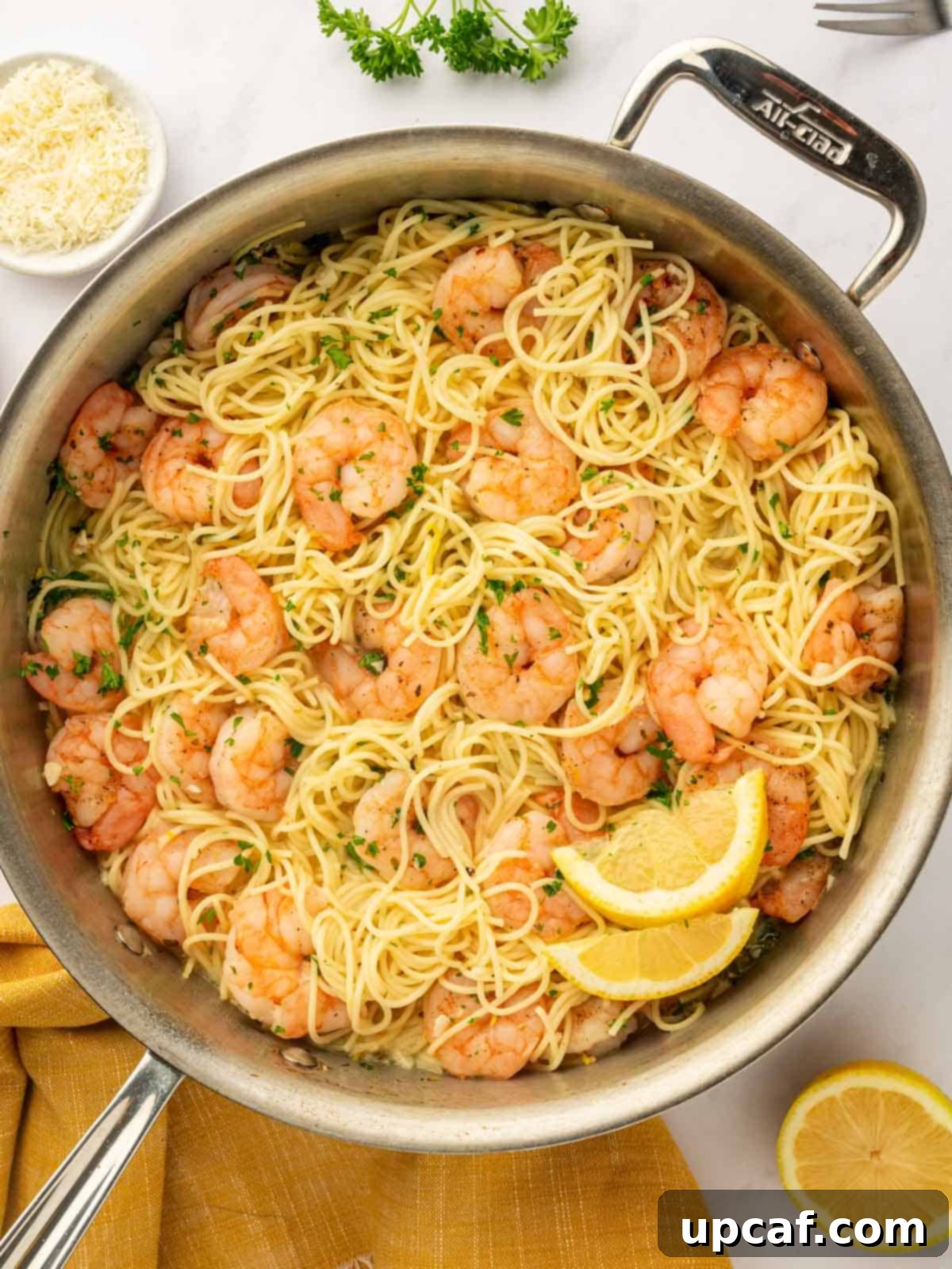 A skillet of pasta and shrimp.