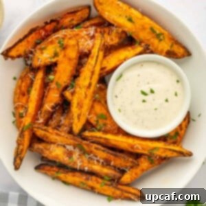 A bowl of sweet potato wedges with dipping sauce.