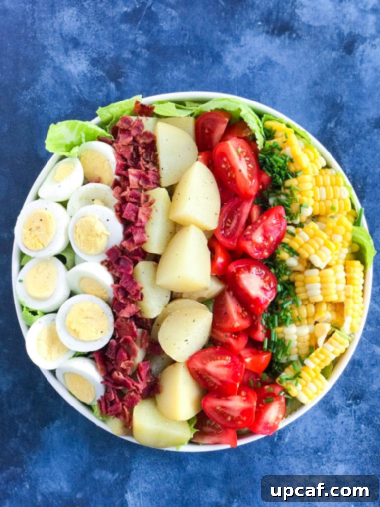 Potato Cobb Salad in a bowl without dressing, showing the arranged ingredients