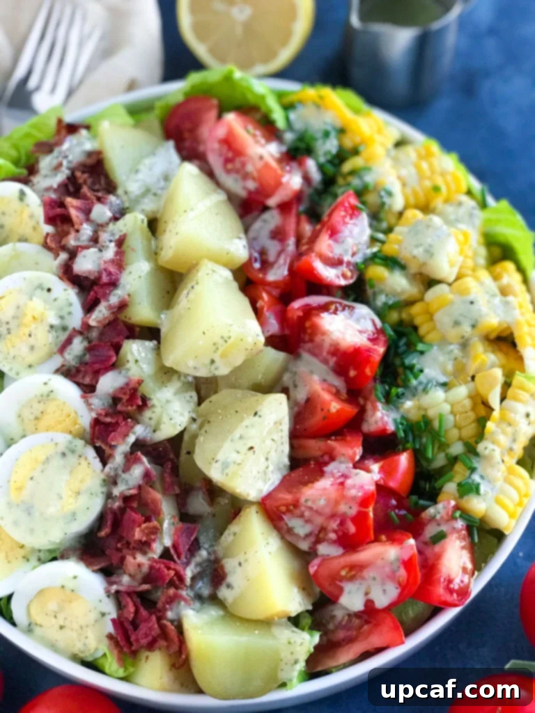 The Potato Cobb Salad with dressing drizzled on top, ready to serve