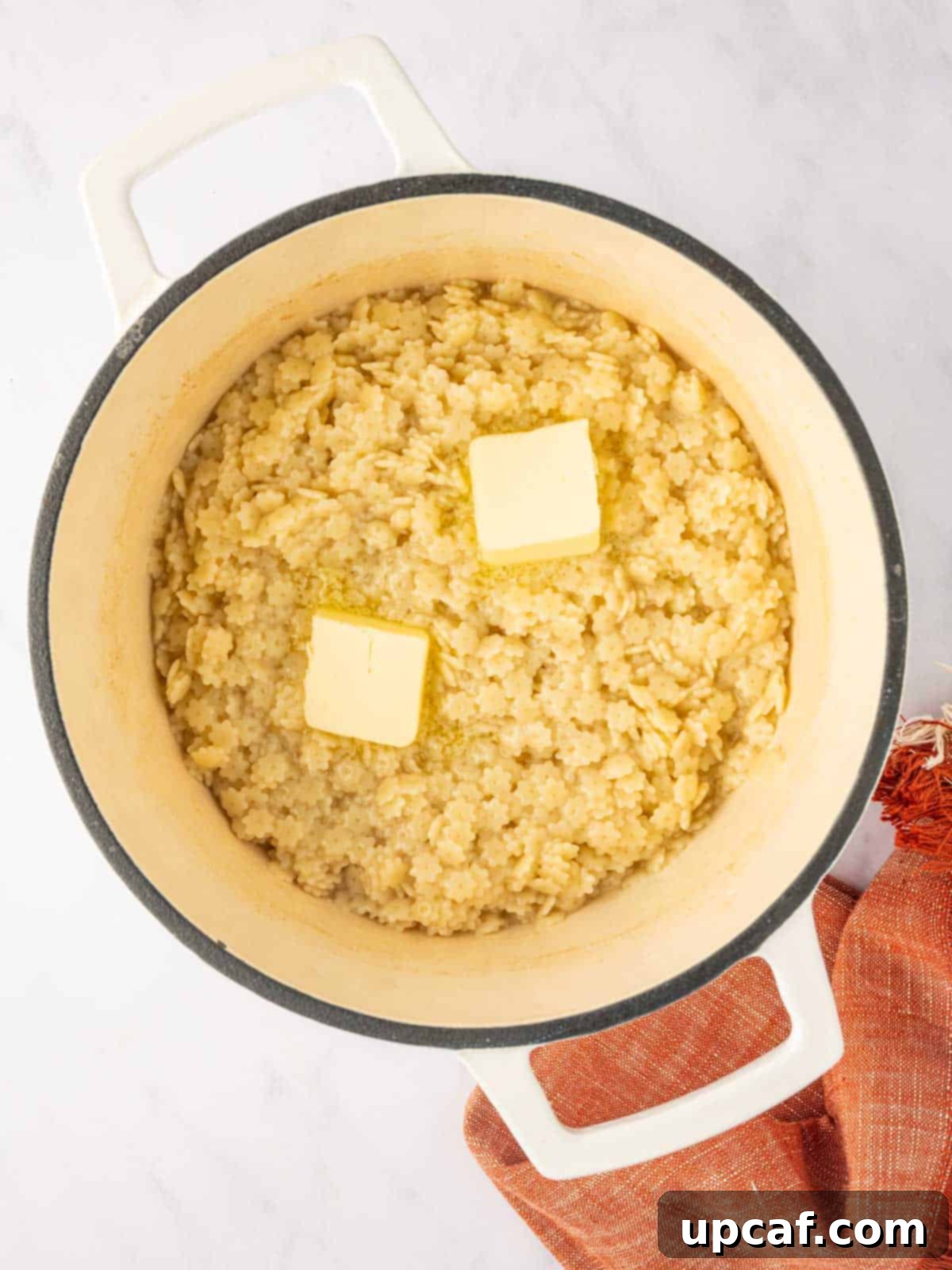 Butter melts over a dutch oven of pastina pasta noodles, ready for cheese.