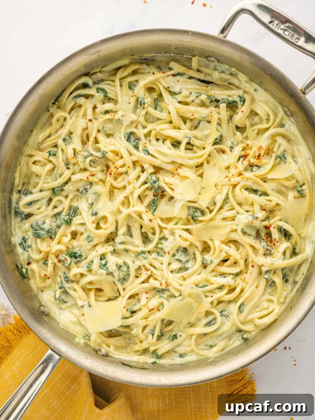Cheesy pasta in a skillet, showcasing a creamy, herb-infused sauce and perfectly cooked noodles.
