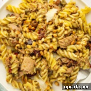 Mediterranean Tuna Pesto Pasta 9 A plate of tuna pesto pasta, ready to eat with a fork.