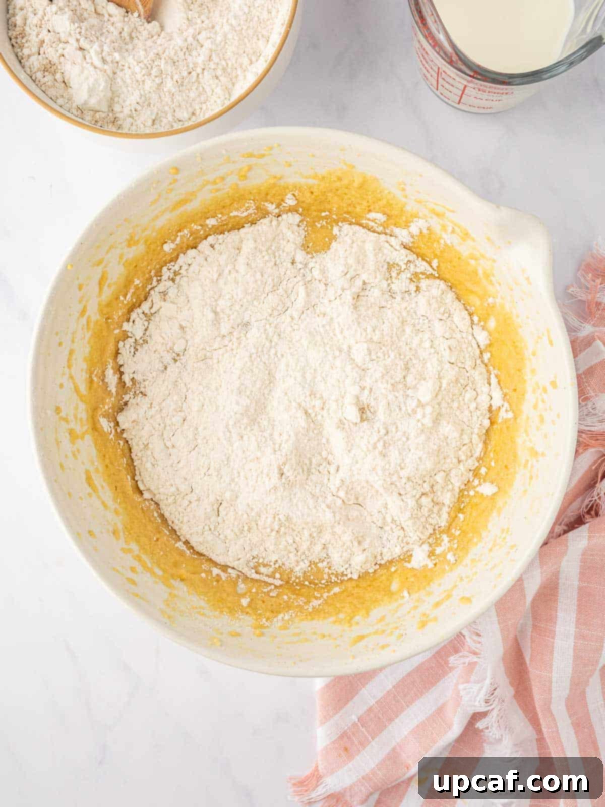 Caramelized Pear Crown Cake 11 Dry ingredients are gradually combined with wet ingredients to form cake batter.