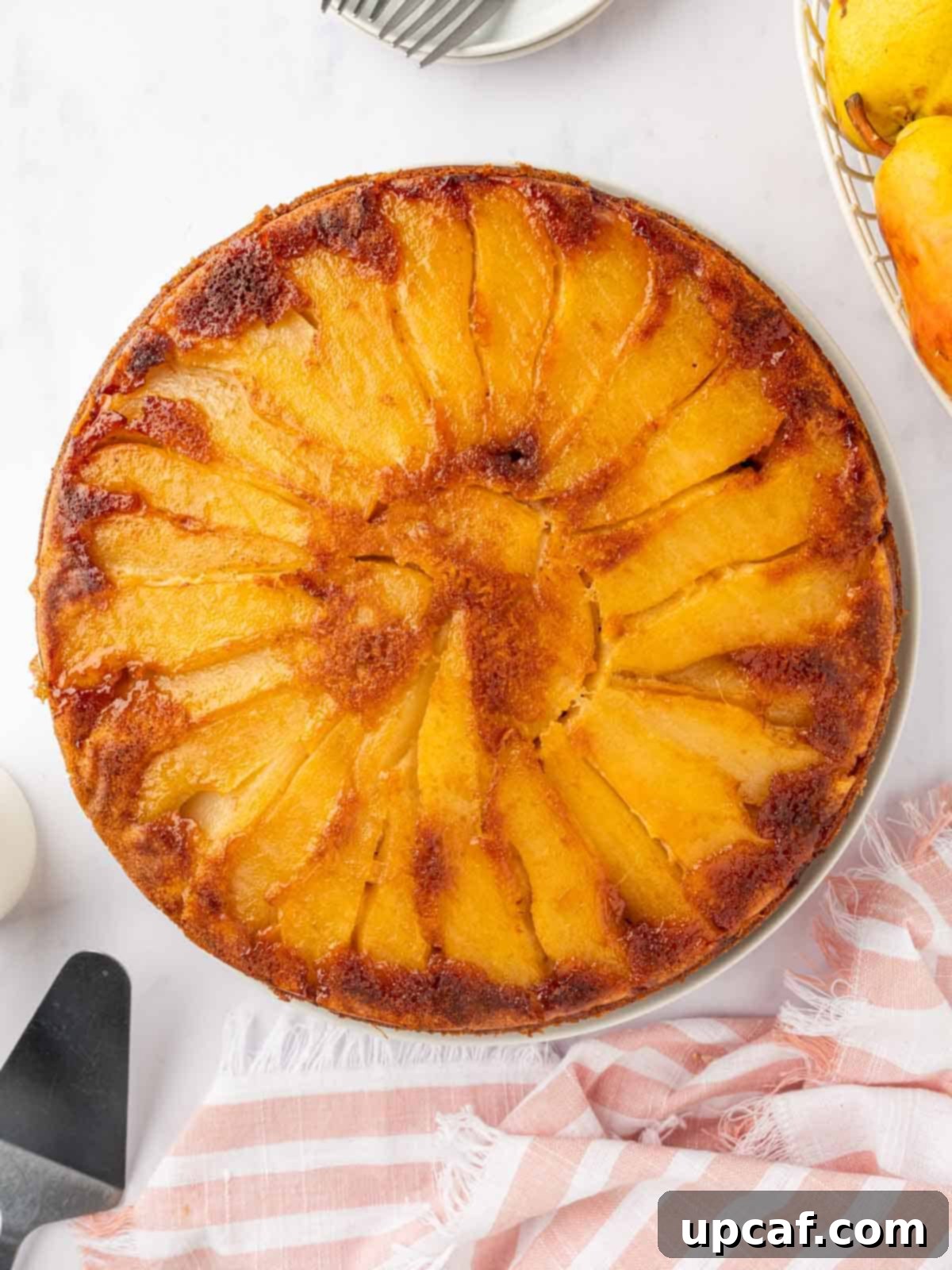 Caramelized Pear Crown Cake 15 Whole pear upside down cake on a platter, ready to be served.