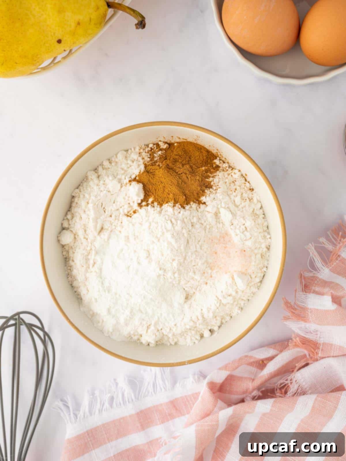Caramelized Pear Crown Cake 8 Dry ingredients are whisked together in a bowl, ready for the batter.
