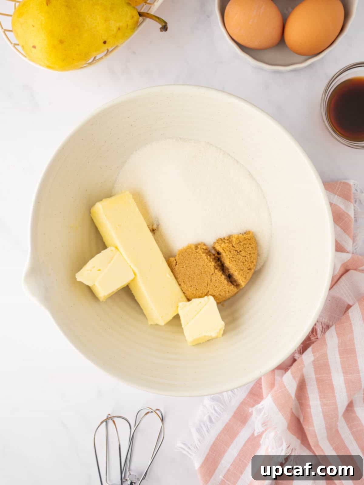 Caramelized Pear Crown Cake 9 Softened butter and sugars are combined in a mixing bowl.