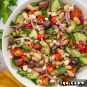 A large bowl of salad with beans and veggies.