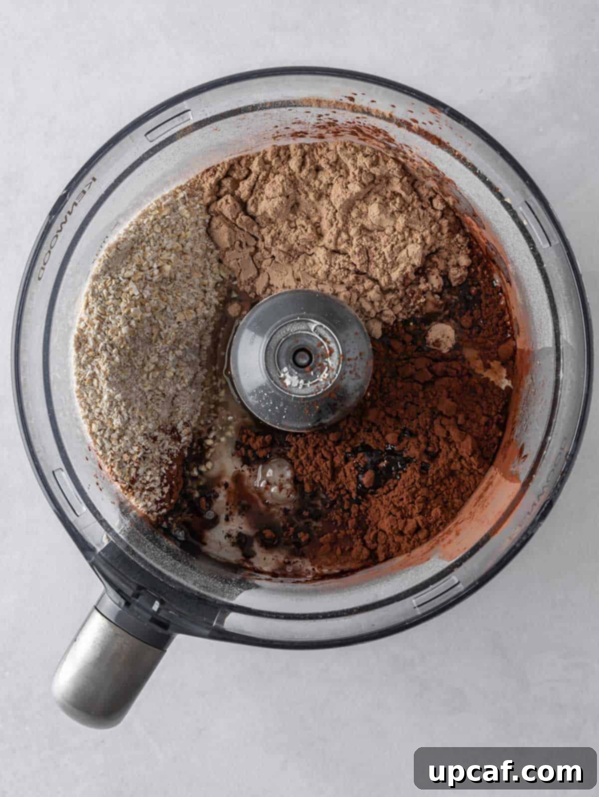 Ultimate Chocolate Protein Stacks 6 Ingredients for pancakes are mixed in a food processor.