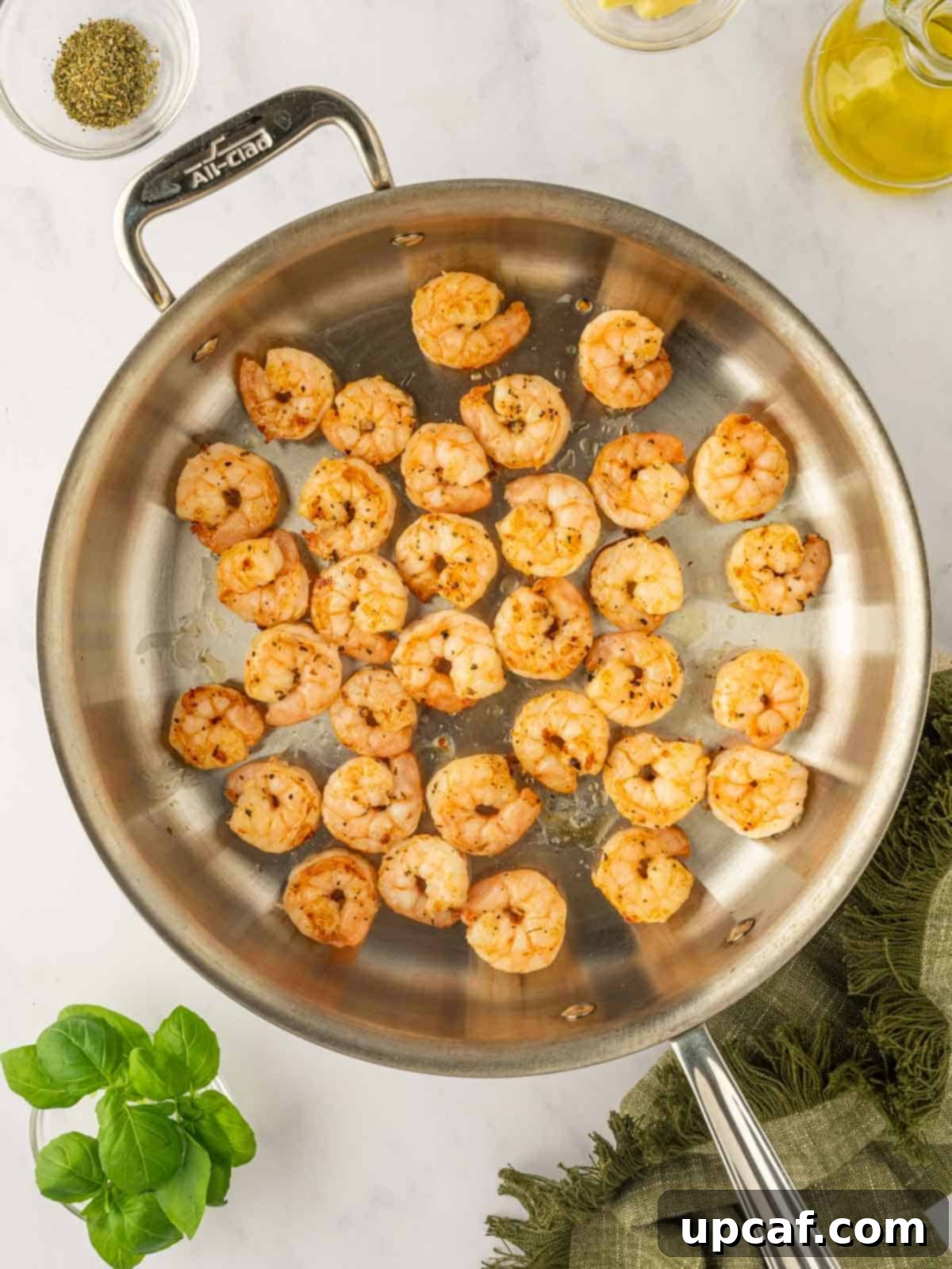 Saute the shrimp in a skillet.