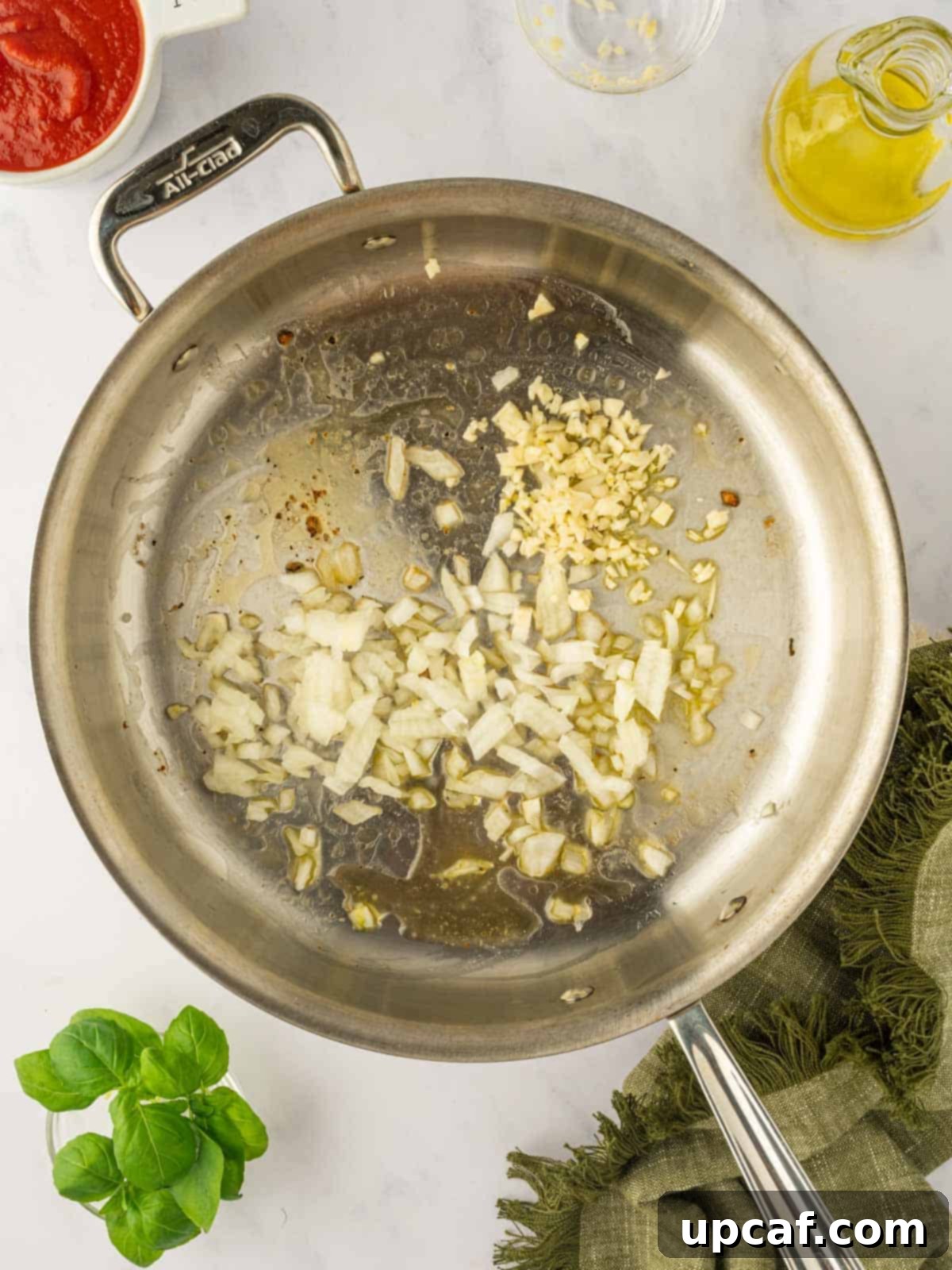 Saute garlic and onions in a skillet.