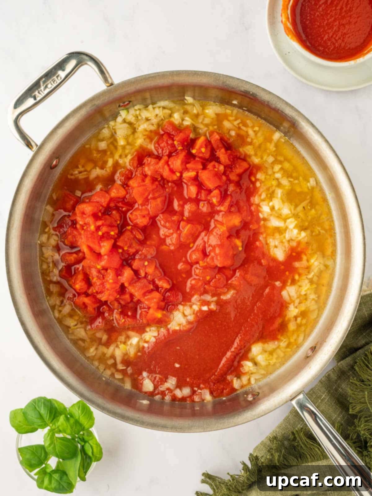 Add the tomatoes to the skillet for the pasta sauce.