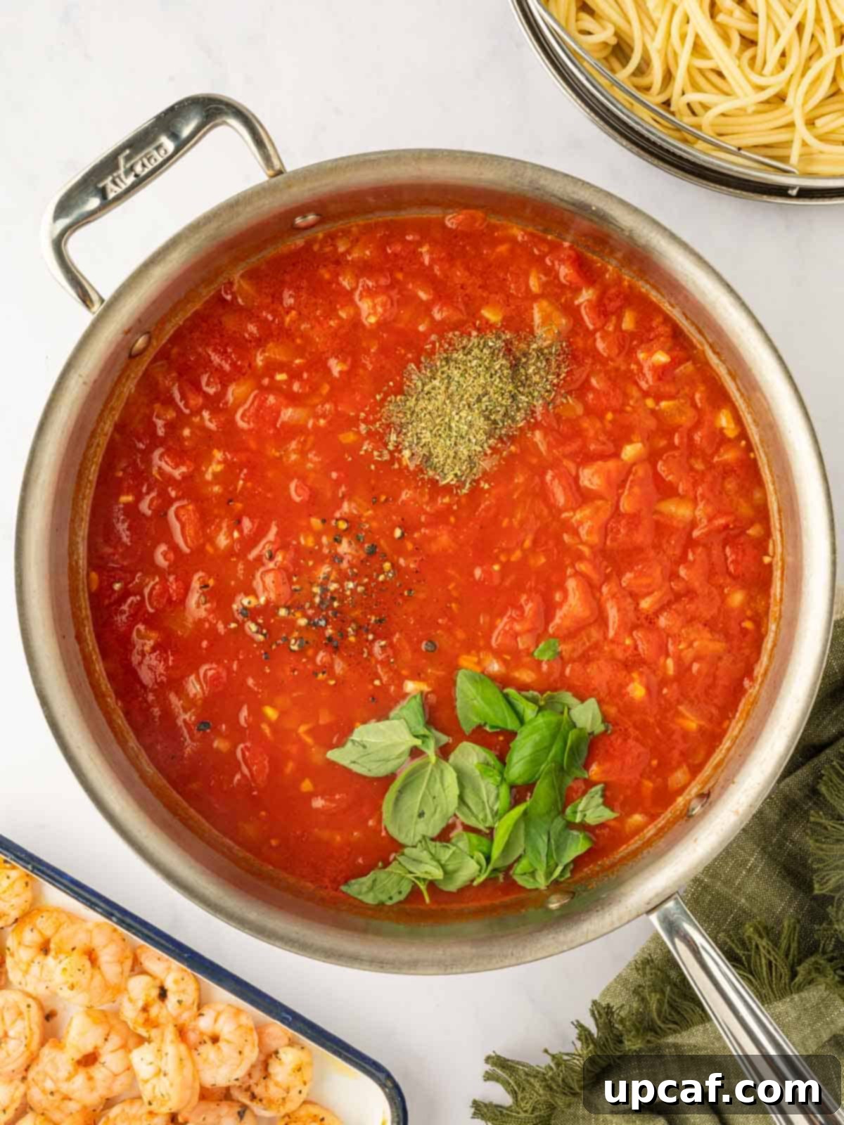 Add seasoning and herbs to the homemade pasta sauce.