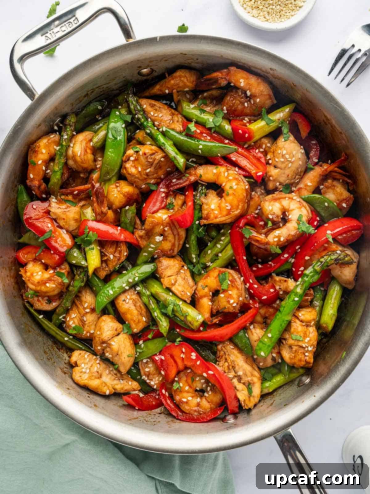Surf and Turf Stir Fry 2 Chicken and shrimp stir fry in a pan, steaming hot and ready to serve.