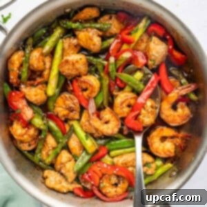 Surf and Turf Stir Fry 12 A spoon serves stir fry with chicken and shrimp.