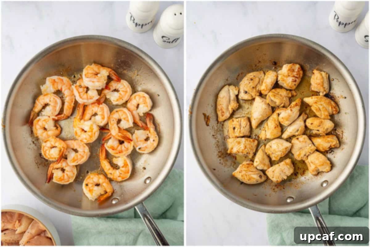 Surf and Turf Stir Fry 5 Shrimp cooking in a hot skillet alongside chicken pieces, separated to cook evenly.