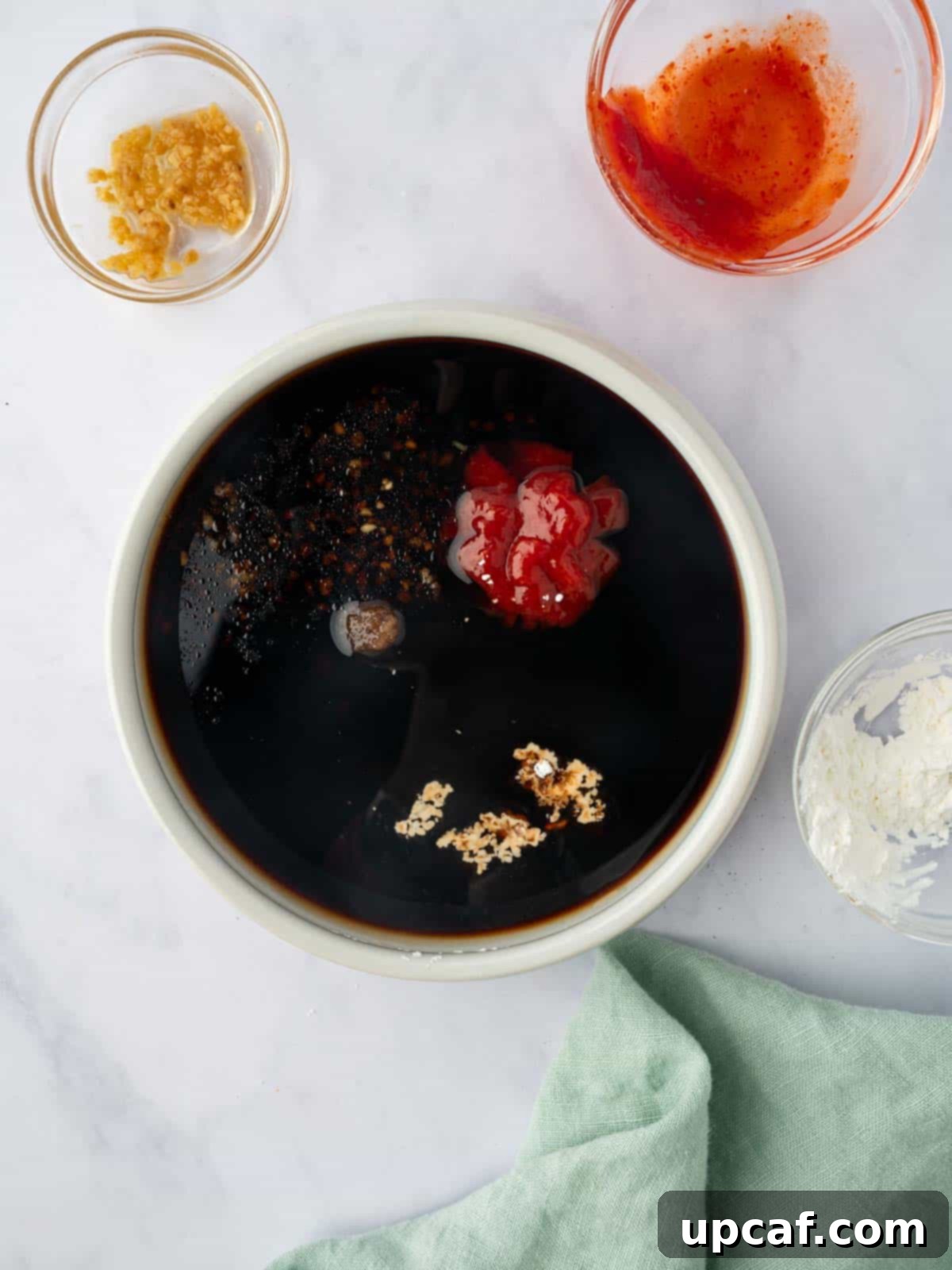 Surf and Turf Stir Fry 7 A bowl containing a mixed stir-fry sauce with ginger, garlic, soy sauce, brown sugar, and cornstarch.