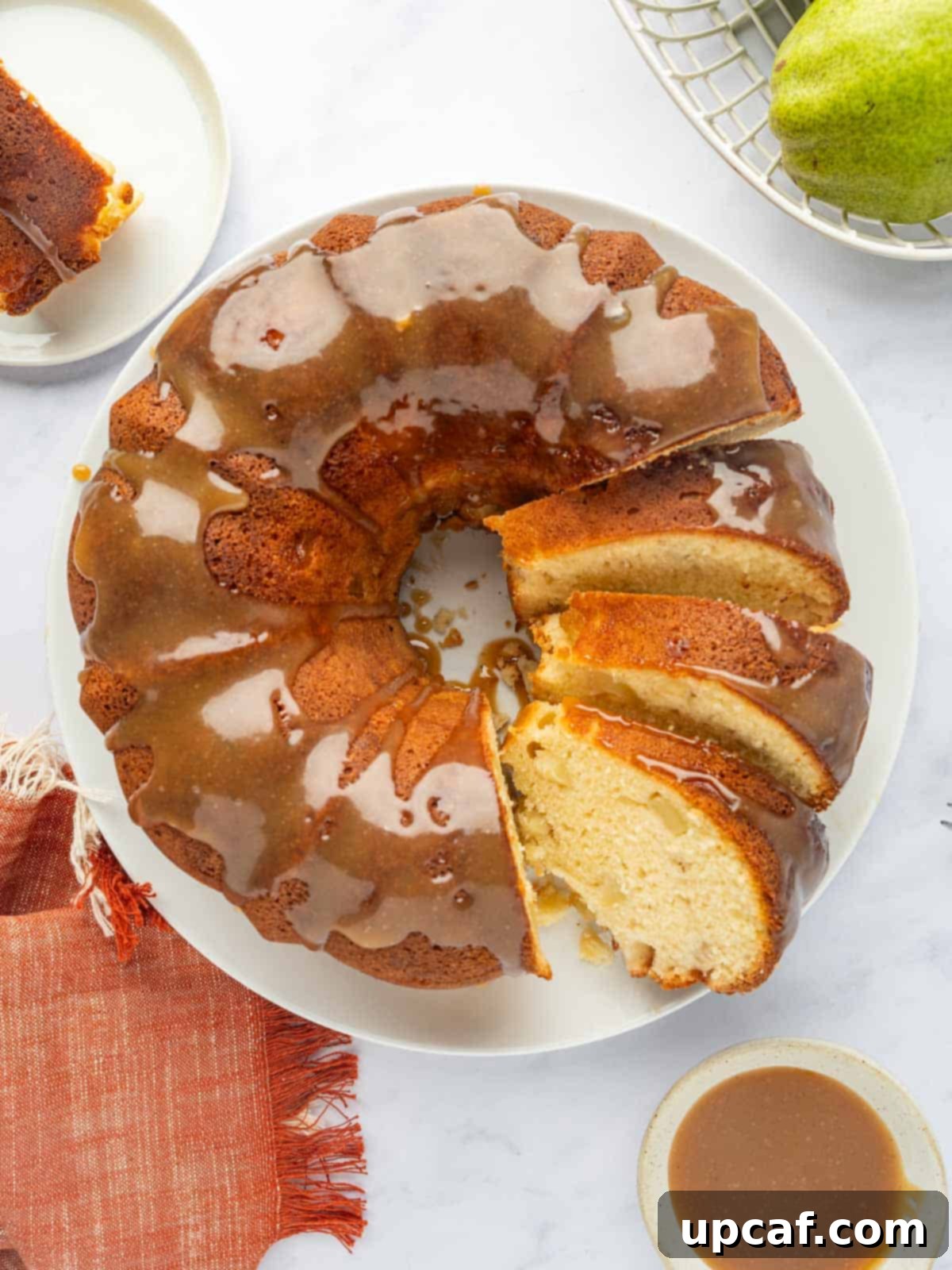 Sliced pear cake with caramel.