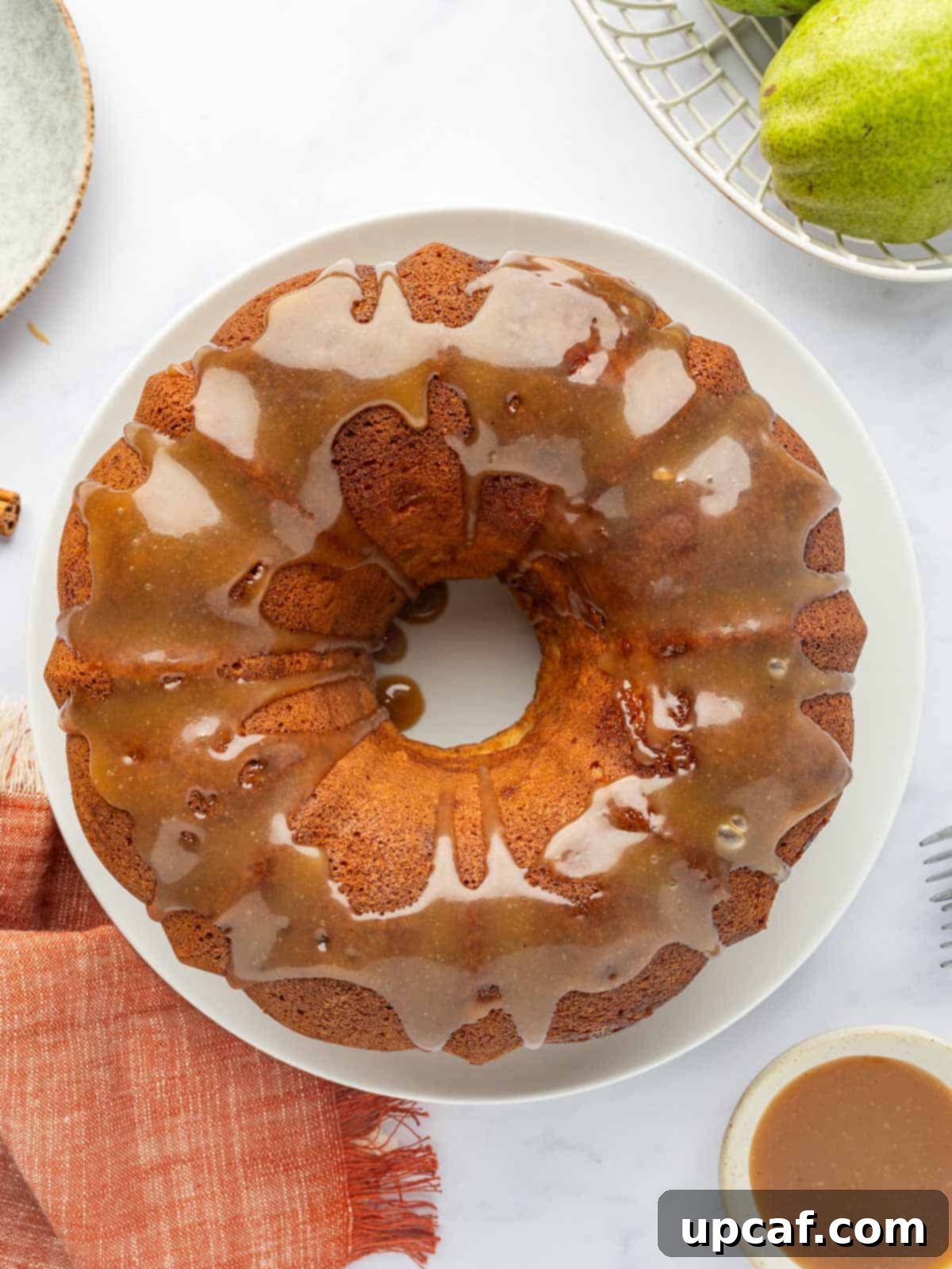 Caramel drizzled over pear bundt cake.